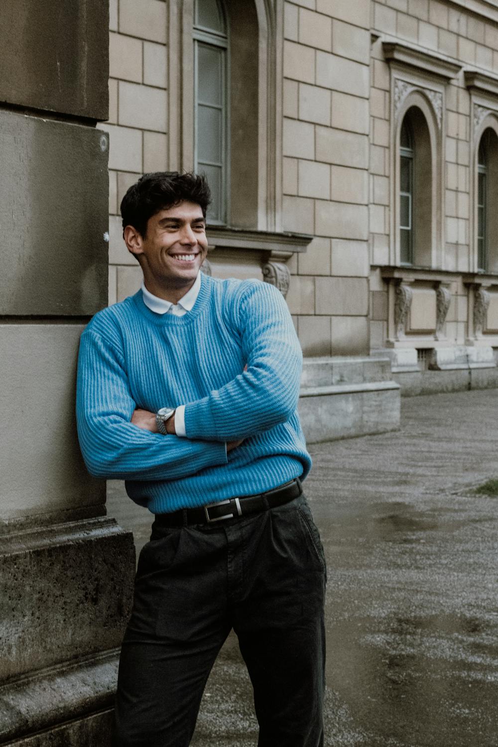 files/free-photo-of-man-in-blue-sweater-leaning-against-building-wall.jpg